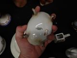a person holding a white porcelain object in their hand