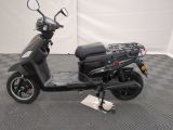 a scooter that is parked on a checkered floor
