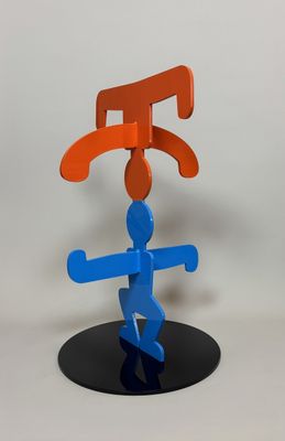 a blue and orange sculpture on a black stand