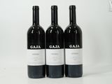 three bottles of wine sitting on top of a white table