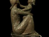 statue of a man and a woman sitting on a marble block