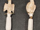 two birds that are sitting on the handles of a bottle