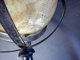 a metal object with a black handle on a table