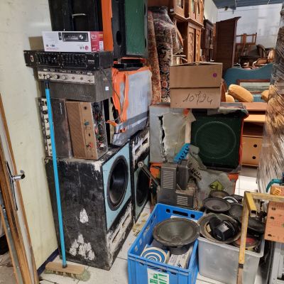 a pile of old appliances and other items in a room
