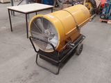 a large yellow blower sitting on a cart in a warehouse