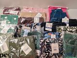 many different types of clothing on display in the store