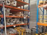 many rolls of toilet paper on the shelves in the warehouse