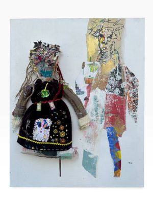 a picture of a doll and a doll on the wall