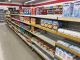 many shelves in a grocery store that have various items on them