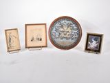 quatre photos encadrées et une horloge posées sur une table