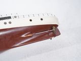 a person holding a brown and white guitar case