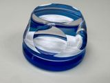 a blue glass bowl with a white swan inside of it