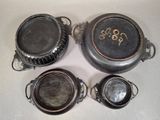 several old pots and pans sitting on top of a table