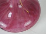 a pink glass vase with a yellow flower in it