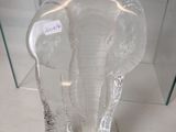 a glass elephant head sitting on a glass table
