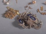 a lot of jewelry that is laying out on the table