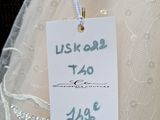 a price tag attached to a wedding dress on a hanger