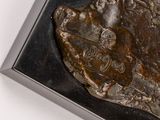 a bronze statue of a man riding a horse on a rock