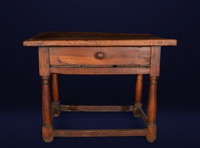 an old wooden table with a drawer on top of it