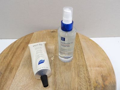 a bottle of lotion and a tube of lotion sitting on a table