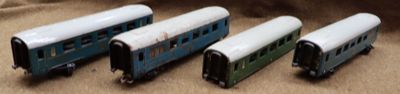 four toy trains sitting on a table next to each other
