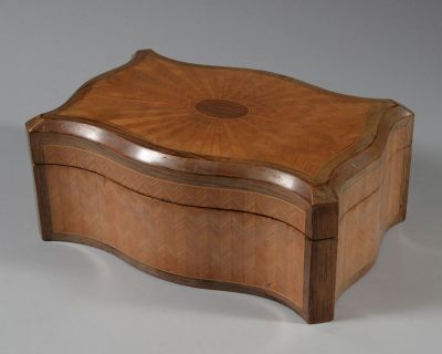 a small wooden box with a decorative design on it