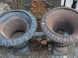 two vases that are sitting next to each other on the ground