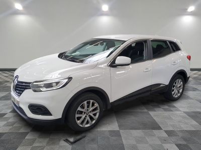 the white suv is parked in the garage on a checkered floor