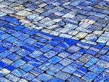 close up of a blue and white mosaic tile floor in a room