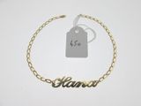 a close up of a gold chain bracelet with a name on it