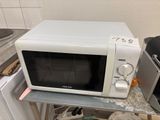 a microwave sitting on top of a counter in a kitchen