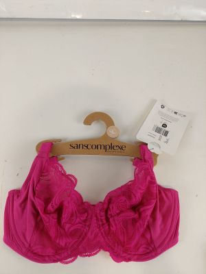 the pink bralette is hanging on a hanger on the wall