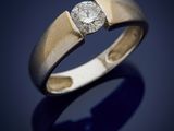 a close up of a gold ring with a diamond on it