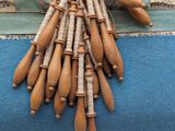 a bunch of wooden baseball bats hanging on a wall