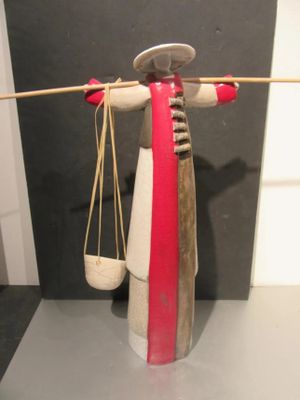 a sculpture of a woman holding a pair of scissors