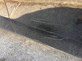 a reflection of a person on a car door