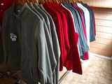 a lot of clothes hanging on a rack in a room