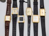 four different types of wrist watches are lined up on a table