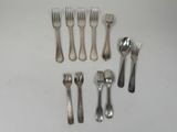 a lot of forks and spoons that are on the table