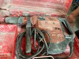 a red tool box with a hammer and other tools in it