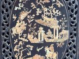 an image of a black and gold plate with birds and flowers on it