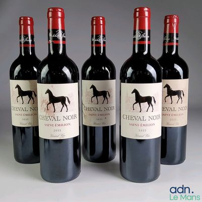 four bottles of red wine are lined up in a row