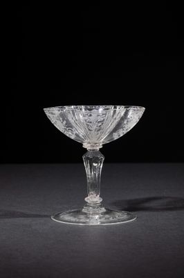 a close up of a glass bowl on a table with a black background