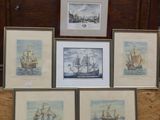 four framed pictures of ships are on display in a room