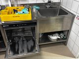 a kitchen with a sink, dishwasher, and other items in it