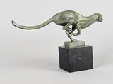 statue of a running cheetah on a marble base