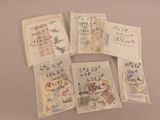 four envelopes with japanese writing on them sitting on top of a table
