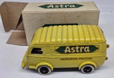 a yellow toy truck that is sitting next to a box