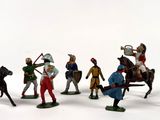 many figurines of men riding on horses and horses
