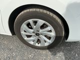 a close up of a tire on a white car